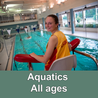 Lifeguard at the pool with green bar with words Aquatics All Ages