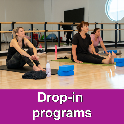 3 adult females sitting on floor with yoga equipment purple bar at the bottom with the text Drop in programs