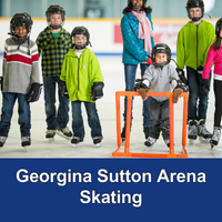 Group of kids skating at indoor rink and wearing safety gear