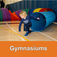 Small child coming out of a colourful fabric tube orange bottom bar with text Gymnasiums