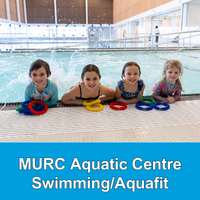 four girls hanging on the edge of a pool with multi-coloured diving rings