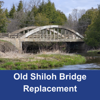 Old concrete bridge with a blue banner with the text Old Shiloh Bridge Replacement