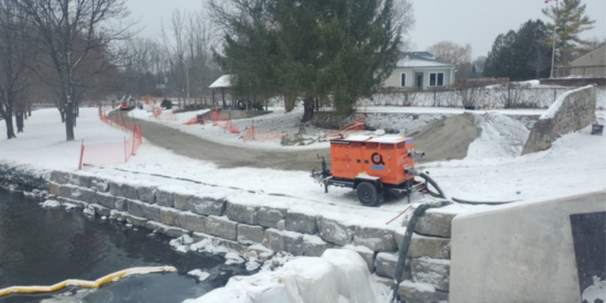 View of construction equipment on the side of the river