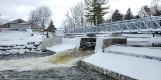 Concrete dam with metal bridge