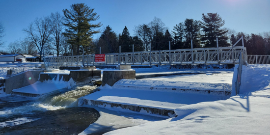 completed dam with metal bridge