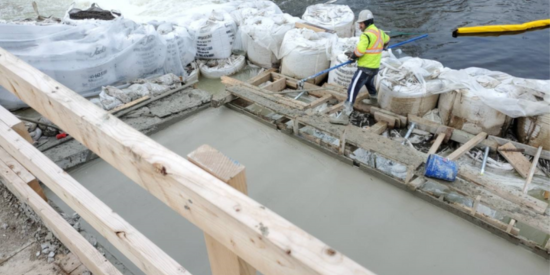 construction worker with freshly poured concrete