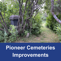 Trees and a headstone covered in greenery with blue bar with the words Pioneer Cemeteries Improvements