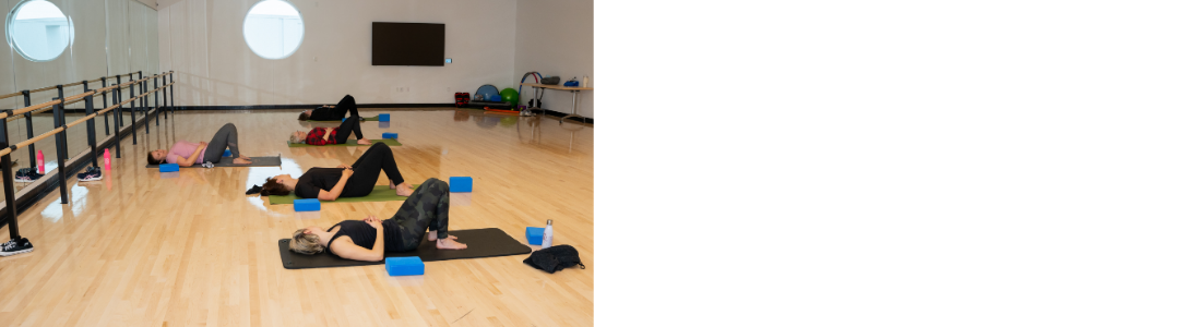 Group of women laying on yoga mats in a studio