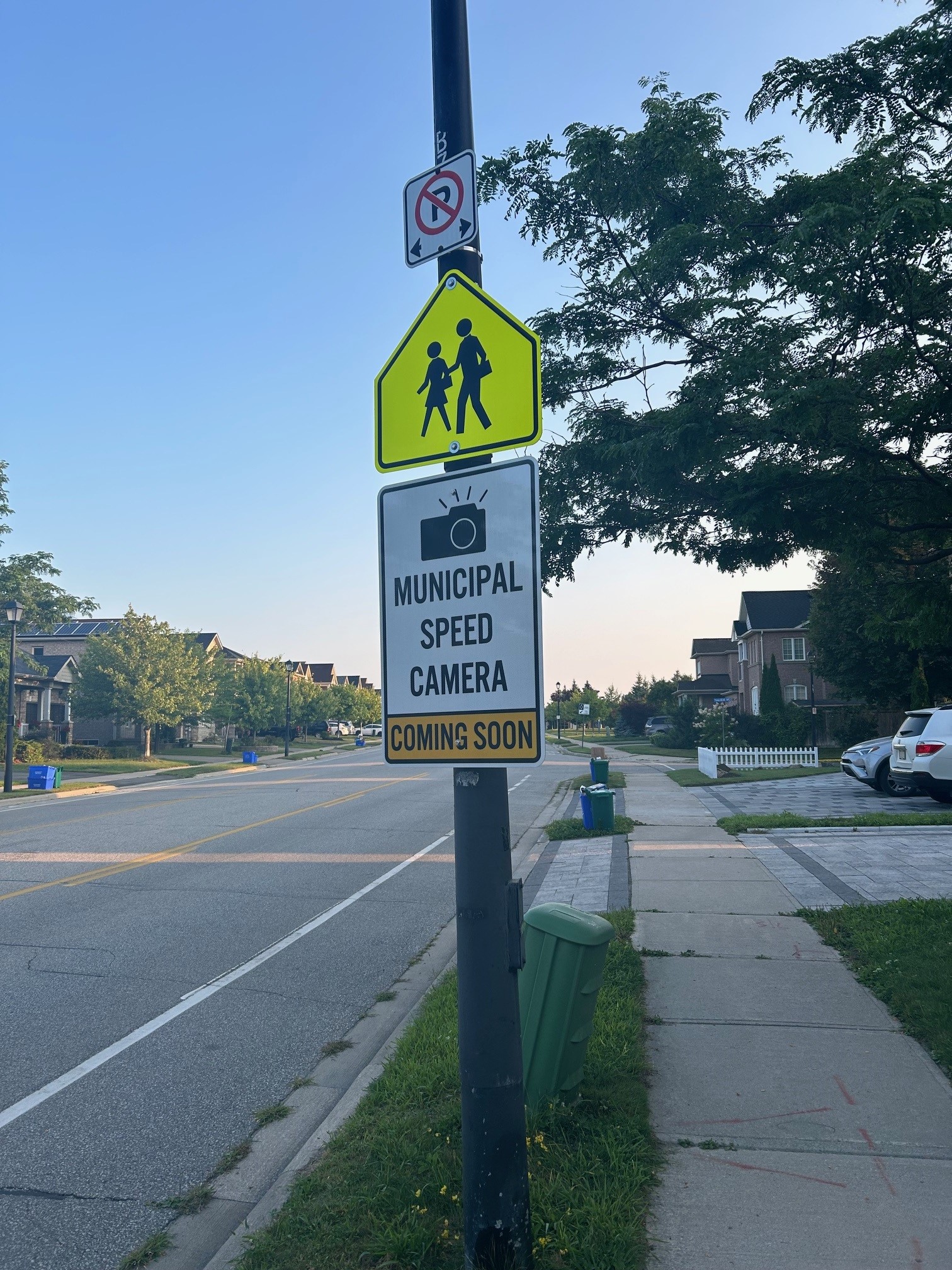 Road with a school sign, no parking and Municipal speed camera coming soon