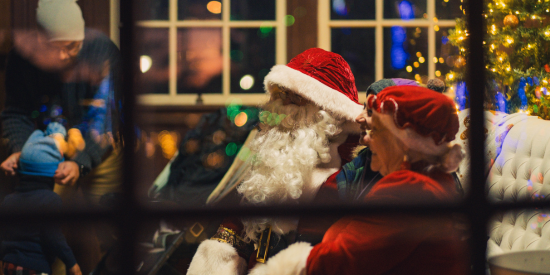 Santa and Mrs. Claus through a window