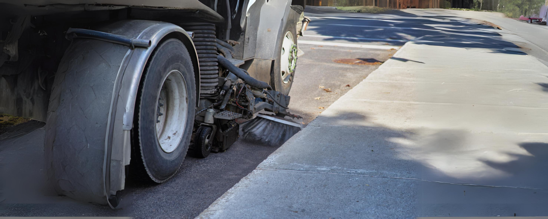 close up of street sweeper on a road